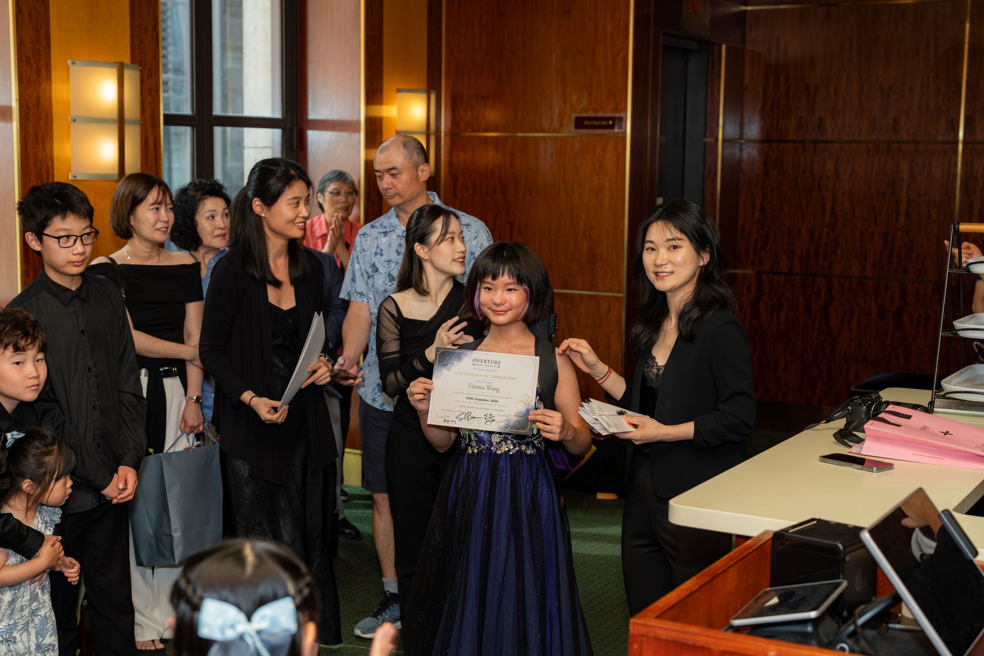 Students receive certificates after the final concert
